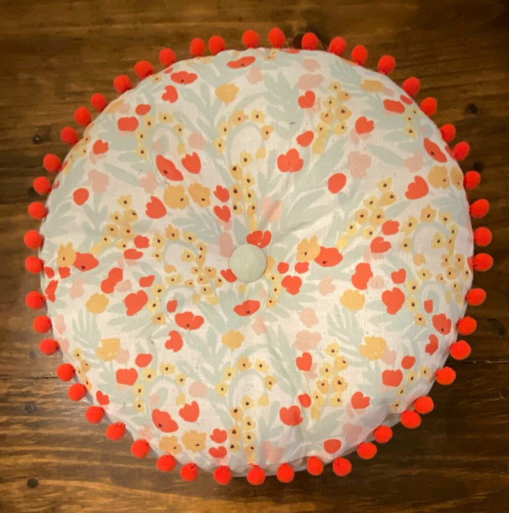 Round Textured Floral Decorative Pillow 14 in White/Orange Pom Pom Trim